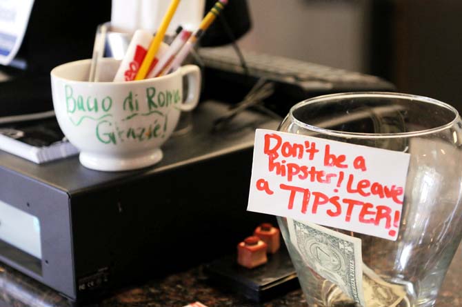 A tip jar sits near the cash register inside of Bacio di Roma, a restaurant on West Chimes Street, on Saturday, Jan. 19.
 