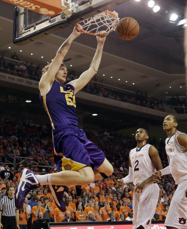 LSU center Andrew Del Piero (55) dunks the ball over Auburn forward Allen Payne (2) and center Asauhn Dixon-Tatum (0) in the first half of an NCAA college basketball game at Auburn Arena in Auburn, Ala., Wednesday, Jan. 9, 2013. (AP Photo/Dave Martin)
 