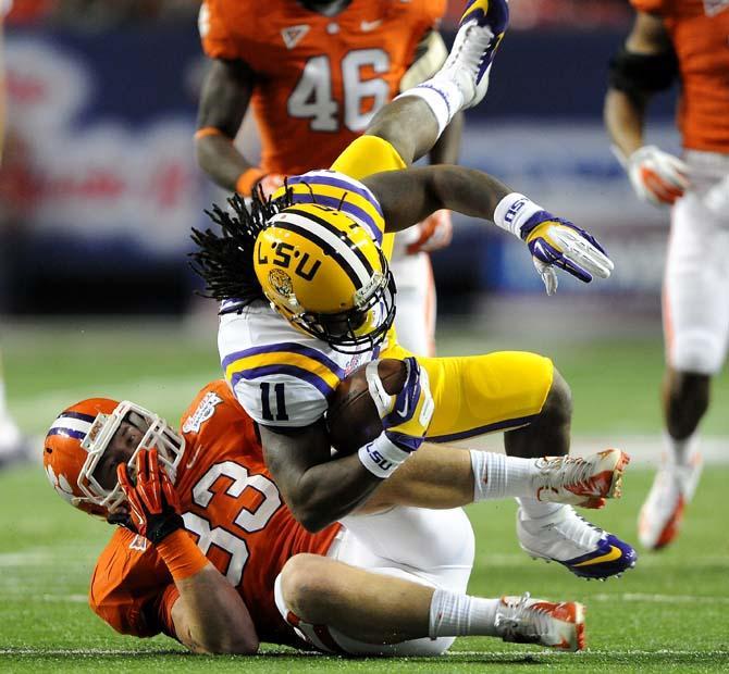 LSU junior running back Spencer Ware (11) is tackled Monday, Dec. 31, 2012 during the Tigers' 24-25 loss in the Chick-fil-A Bowl against Clemson in Atlanta, Ga.
 