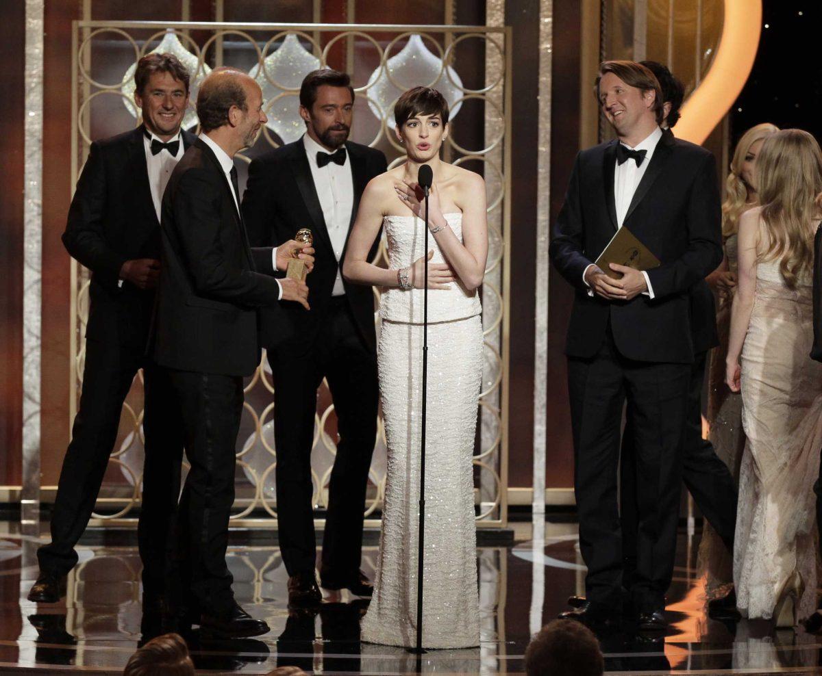 This image released by NBC shows actress Anne Hatheway, center, on stage with the cast and crew of "Les Miserables" after the film won for best musical or comedy during the 70th Annual Golden Globe Awards at the Beverly Hilton Hotel on Jan. 13, 2013, in Beverly Hills, Calif. (AP Photo/NBC, Paul Drinkwater)