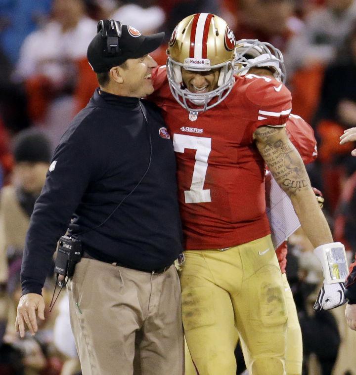 In this Jan. 12, 2012, file photo, San Francisco 49ers head coach Jim Harbaugh celebrates with quarterback Colin Kaepernick (7) after Kaepernick's 56-yard touchdown run against the Green Bay Packers during the third quarter of an NFC divisional playoff NFL football game in San Francisco. Harbaugh made a switch at the most important position on a football field, going from veteran starting quarterback Alex Smith, he of the 18-for-19 passing day in Week 8 and third-in-the-league 104.1 passer rating after what turned out to be his last start, to untested, second-year backup Colin Kaepernick. (AP Photo/Ben Margot, File)
 