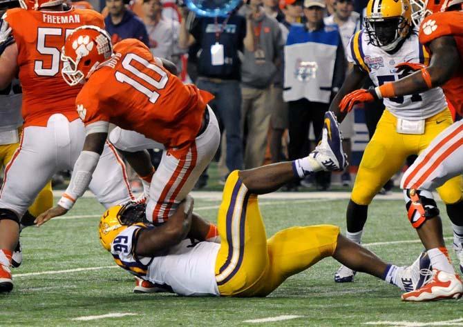 LSU junior defensive end Sam Montgomery (99) sacks Clemson junior quarterback Tajh Boyd (10) Dec. 31, 2012 during LSU's 24-25 loss to Clemson in the Chick-fil-A Bowl in Atlanta, Ga.
 