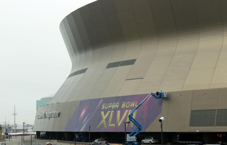 A person works on the Super Bowl sign at the Superdome in New Orleans on Monday, Jan. 14, 2013. NFL football's Super Bowl XLVII is scheduled for Sunday, Feb. 3, in New Orleans. (AP Photo/Janet McConnaughey)
 