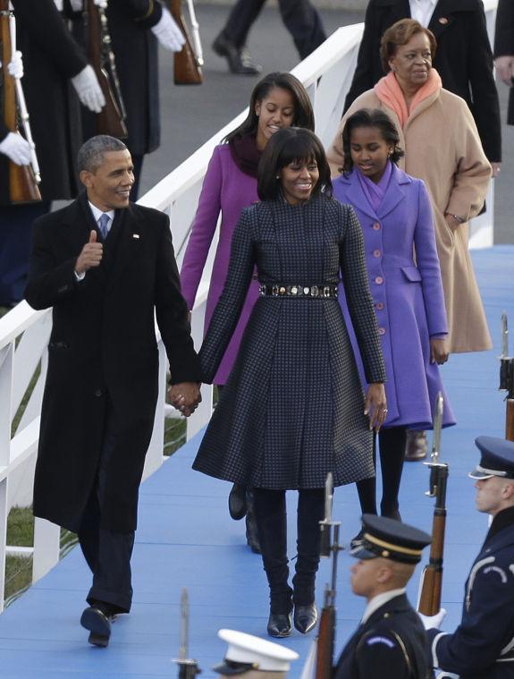 President Barack Obama, first lady Michelle Obama and Malia and Sasha Obama and Michelle Obama's mother Marian Robinson walk down to the Presidential reviewing stand in front of the White House, Monday, Jan. 21, 2013, in Washington. Thousands marched during the 57th Presidential Inauguration parade after the ceremonial swearing-in of President Barack Obama. (AP Photo/Charlie Neibergall )
 