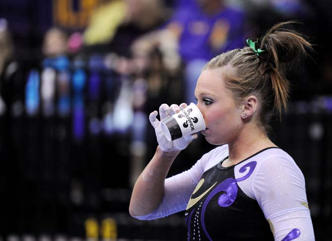 LSU junior all-around Kaleigh Dickson rehydrates before her balance beam performance Jan. 4, 2013 during the Tiger's 196-194 win over NC State in the PMAC.
 