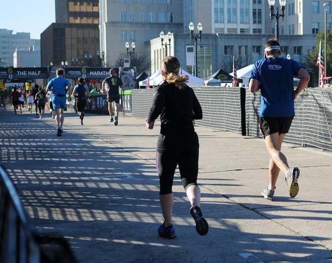 Two runners start into their final sprint before they reach the finish line for the half-marathon downtown on Jan. 20, 2013.
 