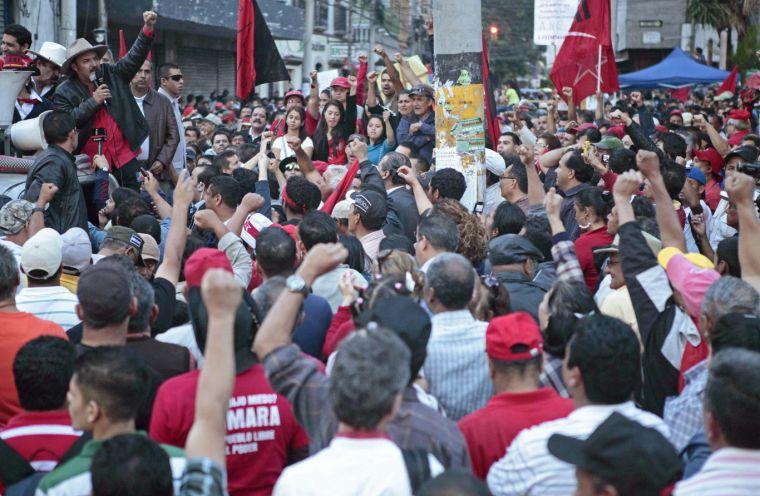 Rasel Tome, coordinator of the Progressive Resistance Movement and member of the opposition Libre party talks to supporters against recent laws approved by congress outside parliament in Tegucigalpa, Honduras, Thursday Jan. 24, 2013. Honduras has been on the brink of bankruptcy for months, as lawmakers put off passing a government budget necessary to pay for basic government services. The country is also grappling with $5 billion in foreign debt, the biggest hole in its history and equivalent to last year&#8217;s entire government budget. The sign reads in Spanish '"The nation is not for sale, you honor it and you defend it. Congressmen with no country, go to a different dog with that bone."(AP Photo/Alberto Arce)
 