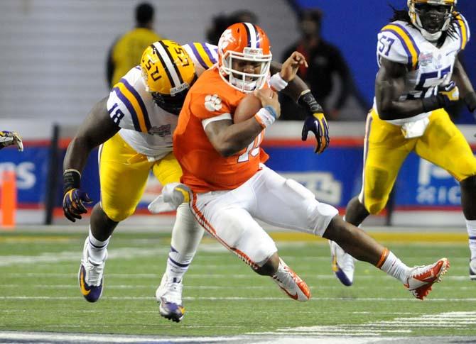 LSU junior defensive tackle Bennie Logan (18) sacks Clemson junior quarterback Tajh Boyd (10) Dec. 31, 2012 during LSU's 24-15 Chick-fil-A Bowl loss in Atlanta, Ga.
 