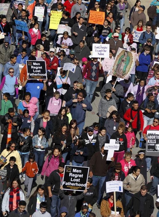 Anti-abortion supporters parade down St. Paul St. during the March for Life in downtown Dallas, Saturday, Jan. 19, 2013 marking the 40th anniversary of Roe v. Wade, the Supreme Court decision that legalized abortion. Between 8,000-10,000 anti-abortion supporters gathered for the March for Life from the Cathedral Guadalupe to the Earle Cabell Federal Courthouse, site of the landmark Roe v Wade lawsuit filing in Dallas. (AP Photo/The Dallas Morning News, Tom Fox)
 