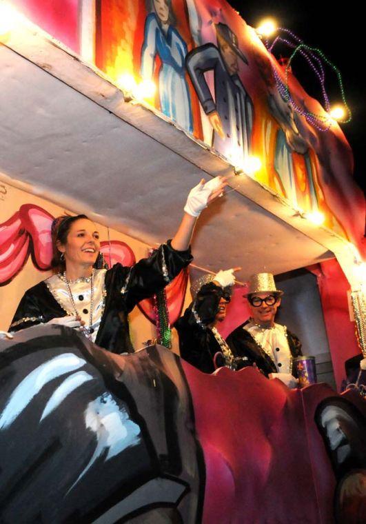 Members of the Krewe of Jupiter and Juno throw beads from their float Saturday Jan. 26, 2013 in front of the Baton Rouge River Center.
 