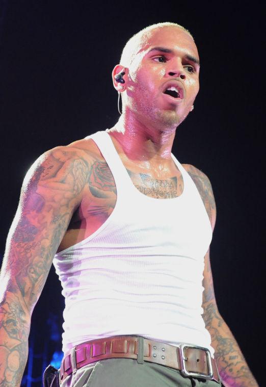 FILE - This Oct. 20, 2011 file photo shows Chris Brown performs live as part of the F.A.M.E Tour at The Staples Center in Los Angeles. Brown is under investigation for an alleged assault in a West Hollywood parking lot, the Los Angeles County Sheriff's Department said early Monday, Jan. 28, 2013. Deputies responding to a report of six men fighting Sunday night found the scene clear, but were told by witnesses that there had been a brief fight over a parking space. (AP Photo/Katy Winn, file)
 