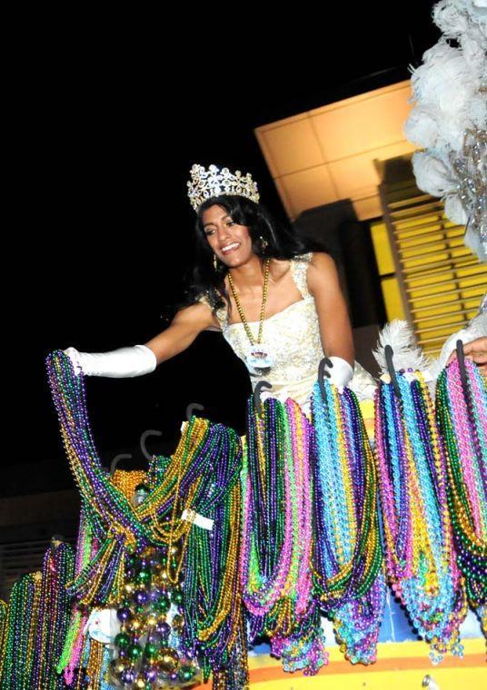 A member of the Krewe of Jupiter and Juno throws beads from a float Saturday Jan. 26, 2013 in front of the Baton Rouge River Center.
 