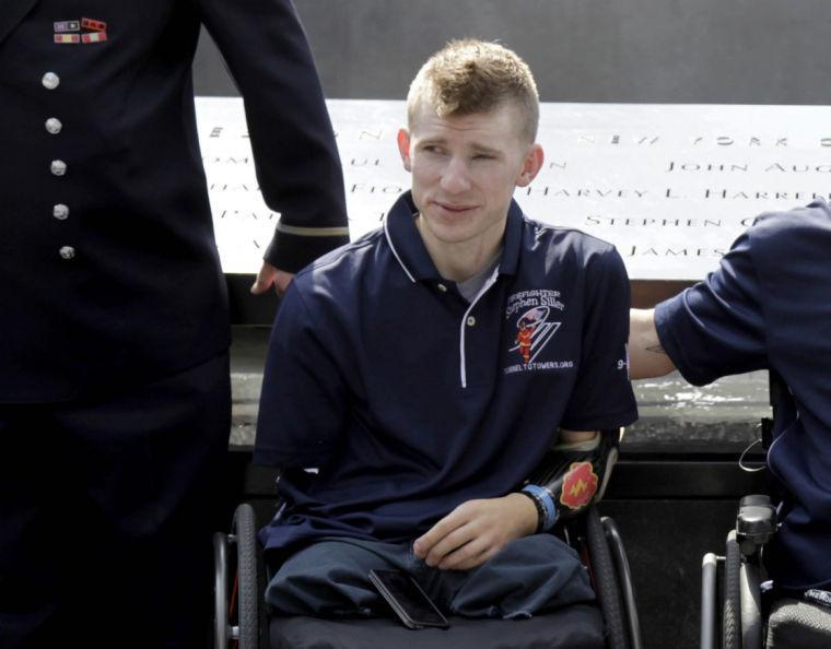 FILE - In this July 4, 2012 file photo, Army Sgt. Brendan Marrocco of Staten Island, N.Y., wearing a prosthetic arm, poses for a picture at the 9/11 Memorial in New York. Marrocco, 26, the first soldier to survive losing all four limbs in the Iraq war, has received a double-arm transplant in Baltimore. His father, Alex Marrocco, said Monday, Jan. 28, 2013 that his son had the operation on Dec. 18, 2012 at Johns Hopkins Hospital. (AP Photo/Seth Wenig, File)
 