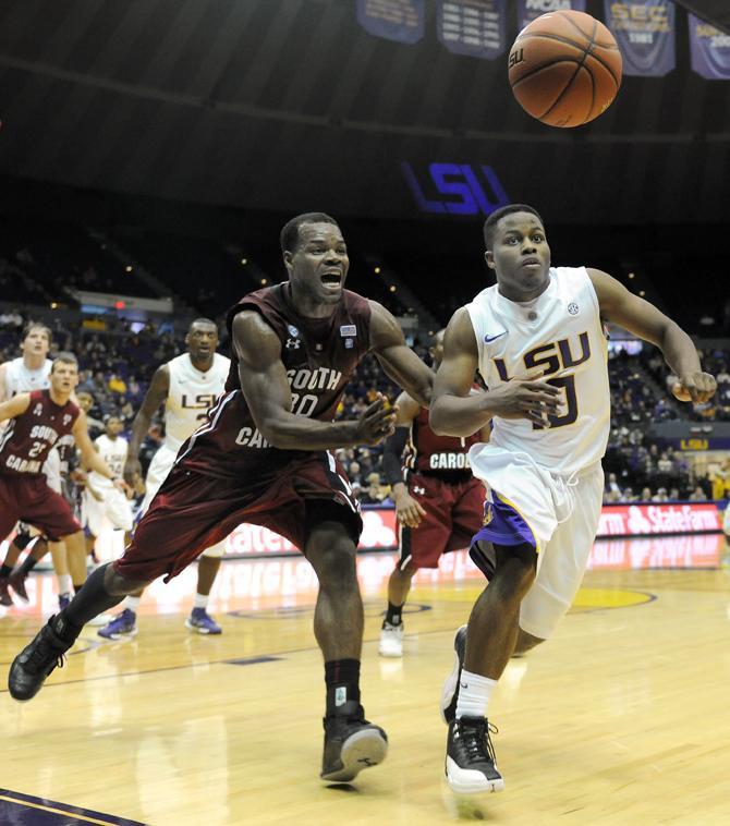 LSU junior guard Andre Stringer (10) and University of South Carolina's senior guard Lakeem Jackson (30) chase Wednesday, Jan. 16, 2012 the loose ball during the Tigers' 73-82 overtime loss to the Gamecocks in the PMAC.
 