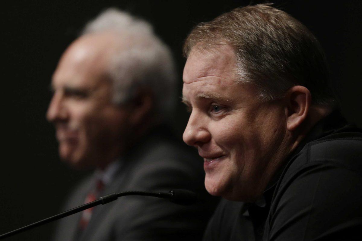 Philadelphia Eagles head coach Chip Kelly, right, accompanied by Eagles owner Jeffrey Lurie, speaks during a press conference at the team's NFL football training facility, Thursday, Jan. 17, 2013, in Philadelphia. (AP Photo/Matt Rourke)