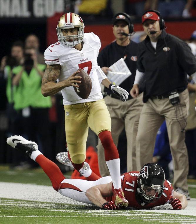 In this Jan. 20, 2013, file photo, San Francisco 49ers' Colin Kaepernick runs past Atlanta Falcons' Kroy Biermann during the first half of the NFL football NFC Championship game in Atlanta. The Baltimore Ravens and San Francisco 49ers meet in Super Bowl XLVII on Sunday, Feb. 3, in New Orleans. (AP Photo/Dave Martin, File)
 