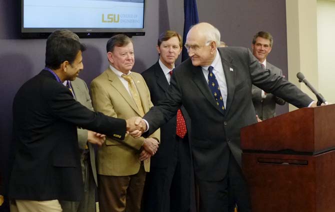 In this file photo, Interim LSU System President and Chancellor William "Bill" Jenkins shakes hands with La. Gov. Bobby Jindal after a $100 million University partnership with the state to expand Patrick F. Taylor Hall was announced. Jenkins is now working to create a midyear budget reduction plan after Jindal announced a midyear budget cut to higher education. The University's state appropriations will drop by $3.4 million.