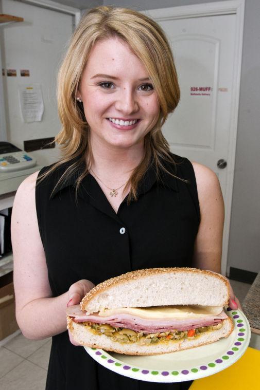 LSU Communication Disorder senior Leigh Ann Town displays Saturday, Jan. 26, 2013 a half of the 926-Muff's muffaletta on Congress Blvd. The 926-Muff is open 7 days a week from 11am-7pm and delivers to LSU.
 