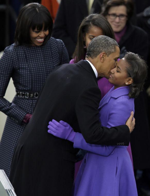 President Barack Obama kisses his daughter Sasha after being sworn-in at the ceremonial swearing-in at the U.S. Capitol during the 57th Presidential Inauguration in Washington, Monday, Jan. 21, 2013. (AP Photo/Evan Vucci)
 