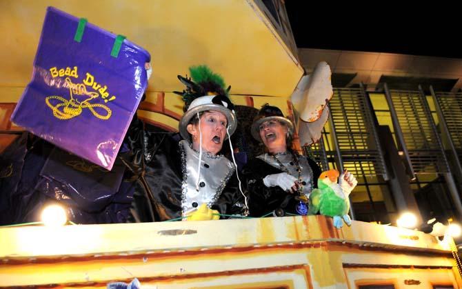 Members of the Krewe of Jupiter and Juno throw beads from their float Saturday Jan. 26, 2013 in front of the Baton Rouge River Center.
 