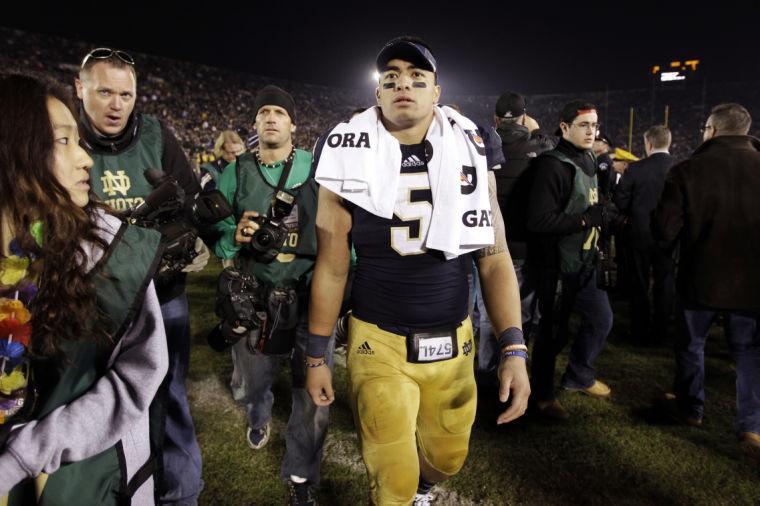 FILE - In this Nov. 17, 2012, file photo, Notre Dame linebacker Manti Te'o walks off the field following an NCAA college football game against Wake Forest in South Bend, Ind. A story that Te'o's girlfriend had died of leukemia _ a loss he said inspired him to help lead the Irish to the BCS championship game _ was dismissed by the university Wednesday, Jan. 16, 2013, as a hoax perpetrated against the linebacker. (AP Photo/Michael Conroy, File)
 