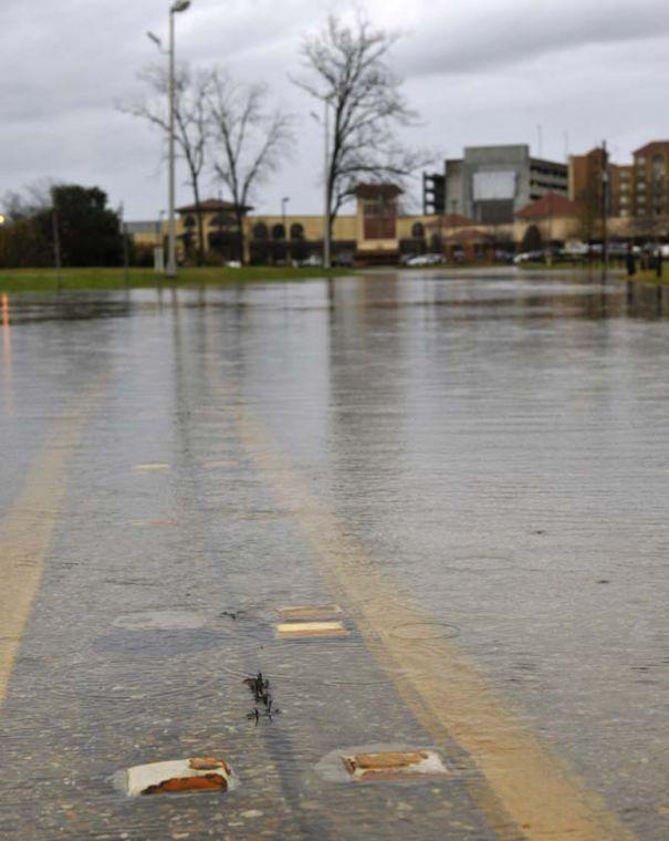 Water floods the road Thursday, Jan. 10, 2013 near the corner of Burbank Drive and Nicholson Drive.
 