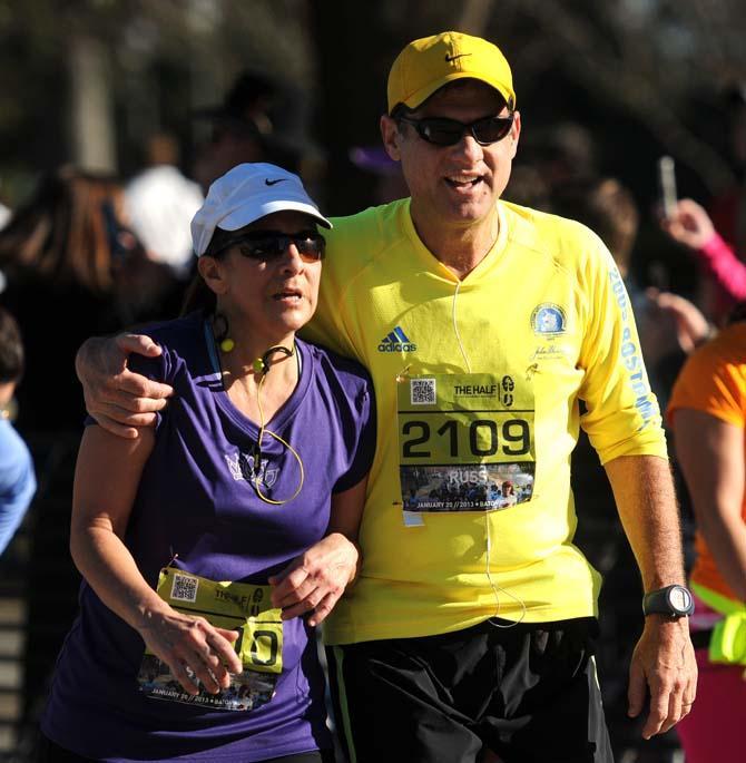 Two runners recover and embrace right after finishing the half marathon downtown as a part of the Louisiana Marathon on Jan. 20, 2013.
 