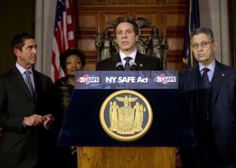 New York Gov. Andrew Cuomo speaks after signing New York's Secure Ammunition and Firearms Enforcement Act into law during a ceremony in the Red Room at the Capitol on Tuesday, Jan. 15, 2013, in Albany, N.Y. Also pictured from left are Senate co-leader Jeffrey Klein, D-Bronx, Senate Democratic Leader Andrea Stewart-Cousins, D-Yonkers, and Assembly Speaker Sheldon Silver, D-Manhattan. (AP Photo/Mike Groll)
 