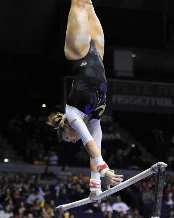 LSU junior bars specialist Mckenzie Fox spins on unven bars Jan. 4, 2013 during the Tiger's 196-194 win over NC State in the PMAC.
 