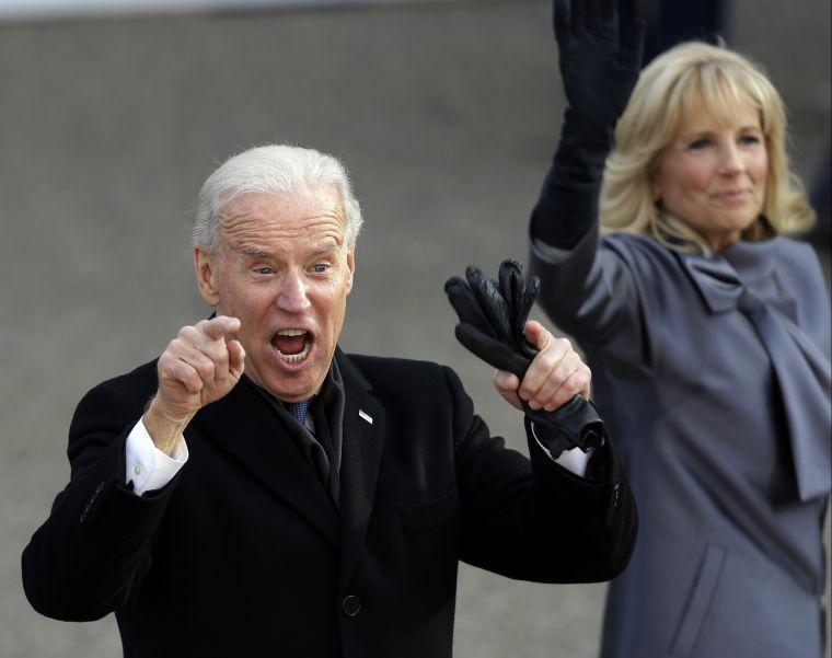 Vice President Joe Biden reacts with his wife, Jill, as they walk down Pennsylvania Avenue en route to the White House, Monday, Jan. 21, 2013, in Washington. Thousands marched during the 57th Presidential Inauguration parade after the ceremonial swearing-in of President Barack Obama. (AP Photo/Gerald Herbert)
 