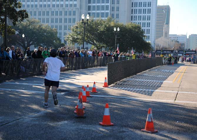 A runner rounds the final corner to enter into the home stretch at the end of the half-marathon course for the Louisiana Marathon downtown on Jan. 20, 2013.
 