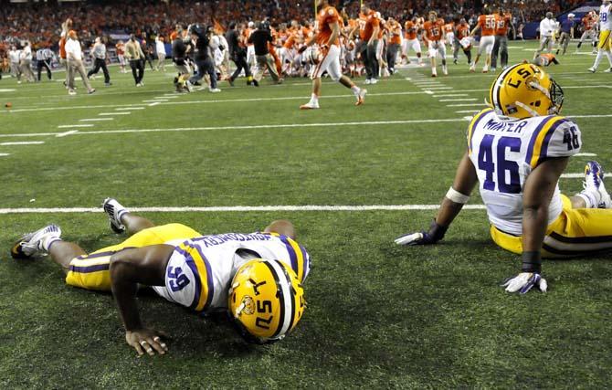 LSU defensive end Sam Montgomery (99) and linebacker Kevin Minter (46) react after LSU's 24-25 loss to Clemson Monday, Dec. 31, 2012 during the Chick-fil-A Bowl against Clemson in Atlanta, Ga.
 