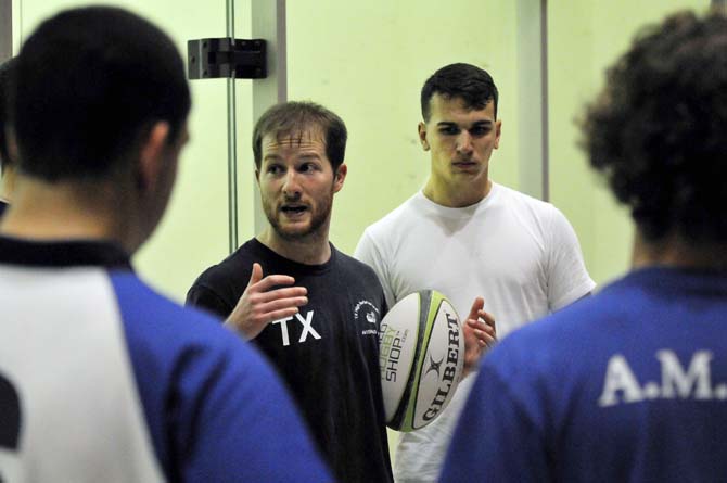 Senior Jarret Gartin, Vice President of the Rugby Club, talks to his teammates Tuesday, Jan. 15, 2013, during their practice. The team had to practice inside two of UREC's racquetball courts due to inclement weather.
 