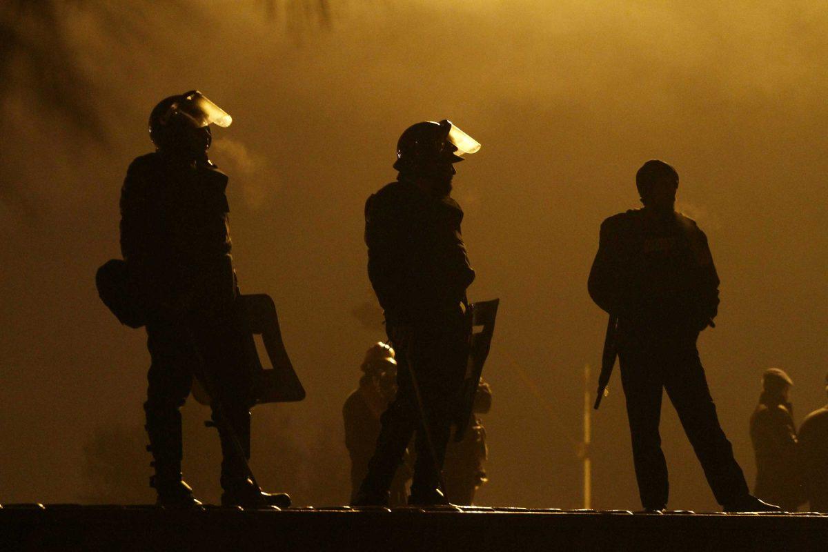 Pakistani police officers stand guards on a shipping container placed to block the supporters of Pakistani Sunni Muslim cleric Tahir-ul-Qadri, to enter into high security area Red Zone during an anti government rally in Islamabad, Pakistan Tuesday, Jan. 15, 2013. Thousands of Pakistanis fed up with political leaders they say are corrupt and indifferent rallied in the Pakistani capital Tuesday, as the fiery cleric who organized the rally called for the government to resign and for his followers to remain on the streets until then. (AP Photo/Anjum Naveed)