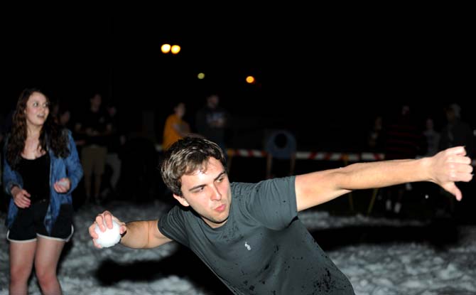 Biochemistry sophomore Brandon Miller prepares to throw a snowball Monday, Jan. 28, 2013, on the parade grounds. There were 7 tons of snow on the ground for the students to play with.
 