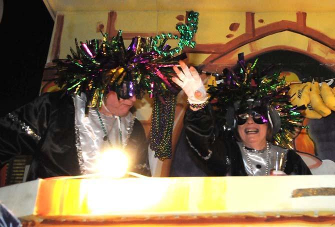 Members of the Krewe of Jupiter and Juno throw beads from their float Saturday Jan. 26, 2013 in front of the Baton Rouge River Center.
 