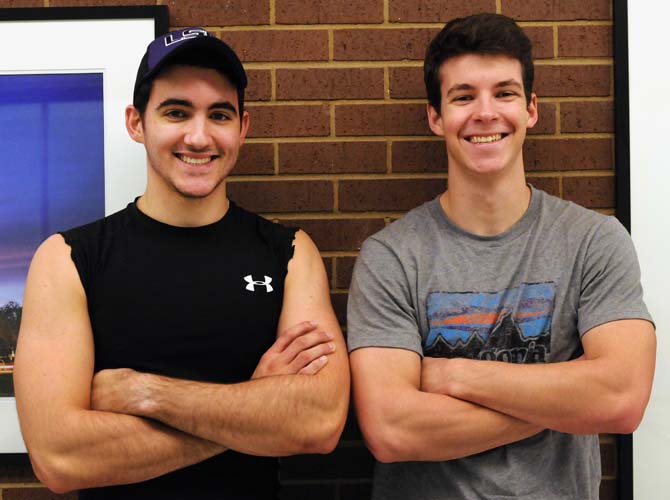 Accounting sophomore Jared Arceneaux, left, poses with fellow accounting sophomore and first cousin Garrett Arceneaux, right, after their workout. They both have the New Year's resolution to meet the Navy Seal's fitness requirements just to see if they can do it.
 