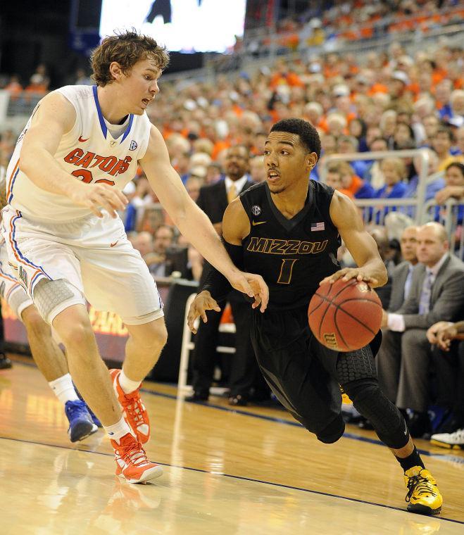 Missouri guard Phil Pressey (1) tries to get around Florida's Erik Murphy (33) during the second half of an NCAA college basketball game in Gainesville, Fla., Saturday, Jan. 19, 2013. Florida won 83-52. (AP Photo/Phil Sandlin)
 