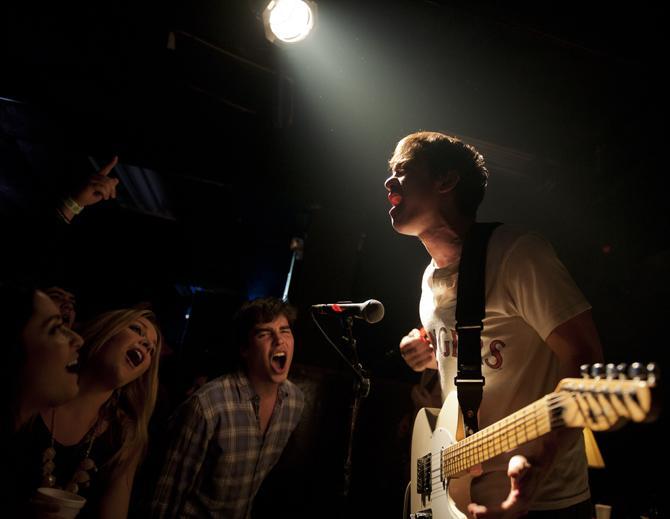 LSU junior mass communication Winston Triolo, vocalist and guartist for the Shoobies, sings Saturday, Jan. 26, 2013 along with the crowd at The House in Tigerland.
 