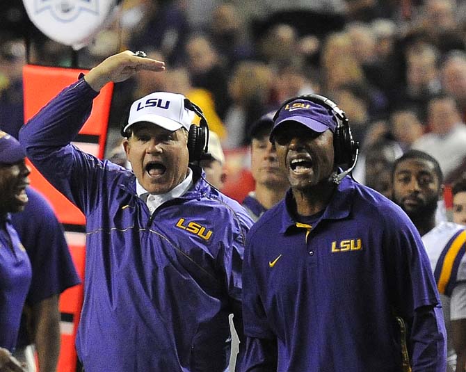 LSU head coach Les Miles and defensive backs coach Corey Raymond yell at players Monday, Dec. 31, 2012 during the Tigers' 24-25 loss in the Chick-fil-A Bowl against Clemson in Atlanta, Ga.
 