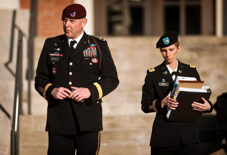 Army Brig. Gen. Jeffrey A. Sinclair, left, leaves a Fort Bragg courthouse with a member of his defense team, Maj. Elizabeth Ramsey, Tuesday, Jan. 22, 2012, after he deferred entering a plea at his arraignment on charges of fraud, forcible sodomy, coercion and inappropriate relationships. Sinclair, who served five combat tours, is headed to trial following a spate of highly publicized military sex scandals involving high-ranking officers that has triggered a review of ethics training across the service branches. (AP Photo/The Fayetteville Observer, Andrew Craft)
 