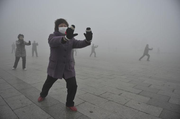 Retirees play Taichi during their morning exercise on a hazy day in Fuyang city, in central China's Anhui province, Monday Jan. 14, 2013. Air pollution is a major problem in China due to the country's rapid pace of industrialization, reliance on coal power, explosive growth in car ownership and disregard for environmental laws. (AP Photo) CHINA OUT
 