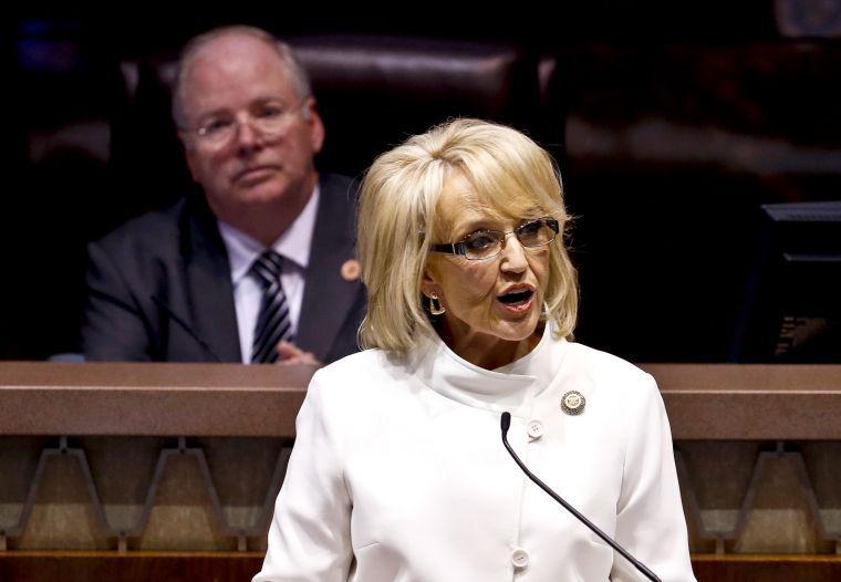 Speaker of the House Andy Tobin, R-Paulden, left, listens as Arizona Gov. Jan Brewer gives her State of the State address at the Arizona Capitol, Monday, Jan. 14, 2013, in Phoenix. (AP Photo/Ross D. Franklin)
 