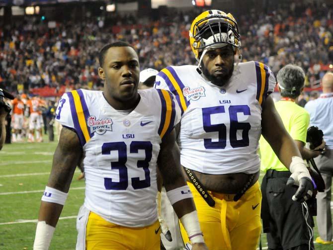 LSU freshman running back Jeremy Hill (33) and freshman offensive lineman Trai Turner (56) walk back to the locker room Dec. 31, 2012 after LSU's 24-25 loss to Clemson in the Chick-fil-A Bowl in Atlanta, Ga.