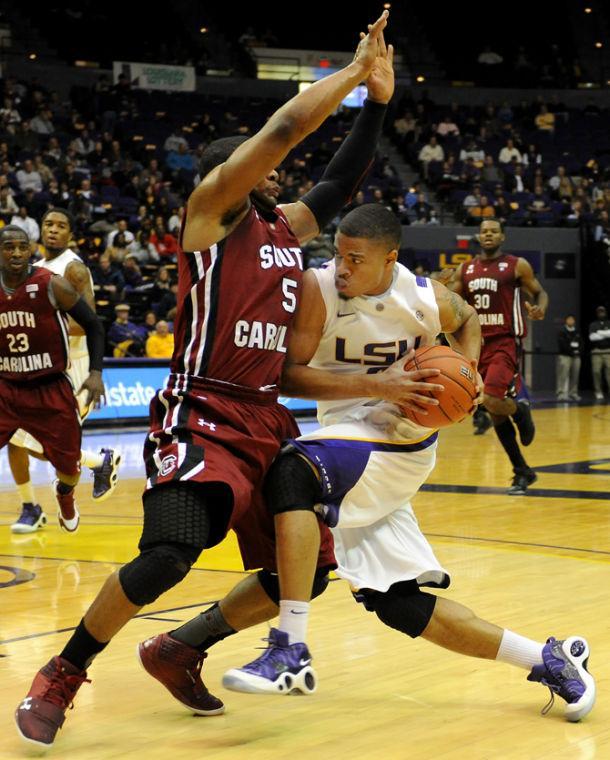 LSU freshman guard Corban Collins (4) drives Wednesday, Jan. 16, 2013 into University of South Carolina's junior guard Eric Smith (5) during the Tigers' 73-82 loss to the Gamecocks in the PMAC.
 