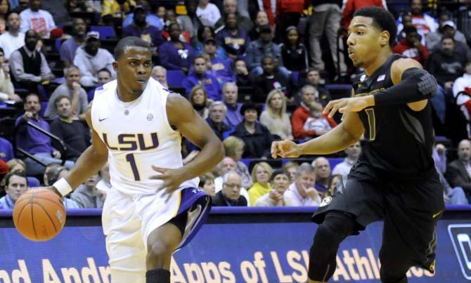 LSU sophomore guard Anthony Hickey (1) dribbles around Missouri junior guard Phil Pressey (1) during the Tigers' 73-70 victory against Mizzou Wednesday Jan. 30, 2013 in the PMAC.
 