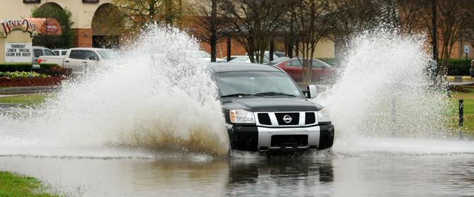 A truck wades on Thursday, Jan. 10, 2013 through the flood waters on Burbank Drive near Nicholson Drive.
 