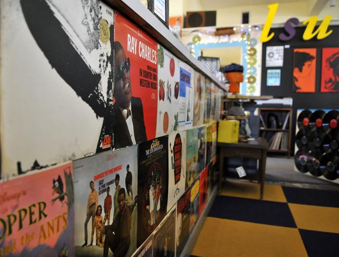 A wall is covered Wednesday, Jan. 23, 2013 in record cover art work at the Atomic Pop Shop on Government Street.
 