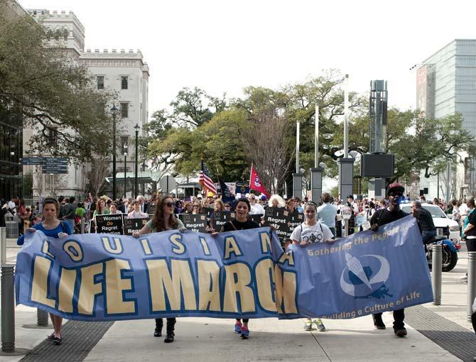 Five protesters lead the third annual Pro-Life March Saturday, Jan. 12, 2013 while holding a banner. The protest marched from the Old State Capitol to the New State Capitol in downtown Baton Rouge.
 