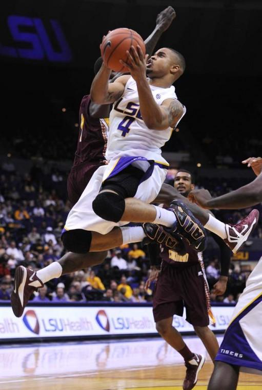 Corban Collins (4), LSU freshman guard, shoots the ball Saturday, Jan. 5, during the LSU vs. Bethune Cookman game.
 